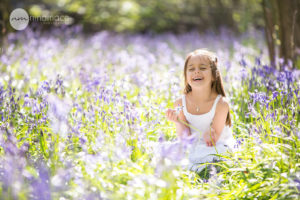 laughing girl in bluebells