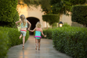 Two little girls skipping