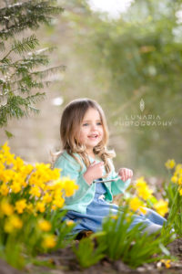 little girl in daffodils